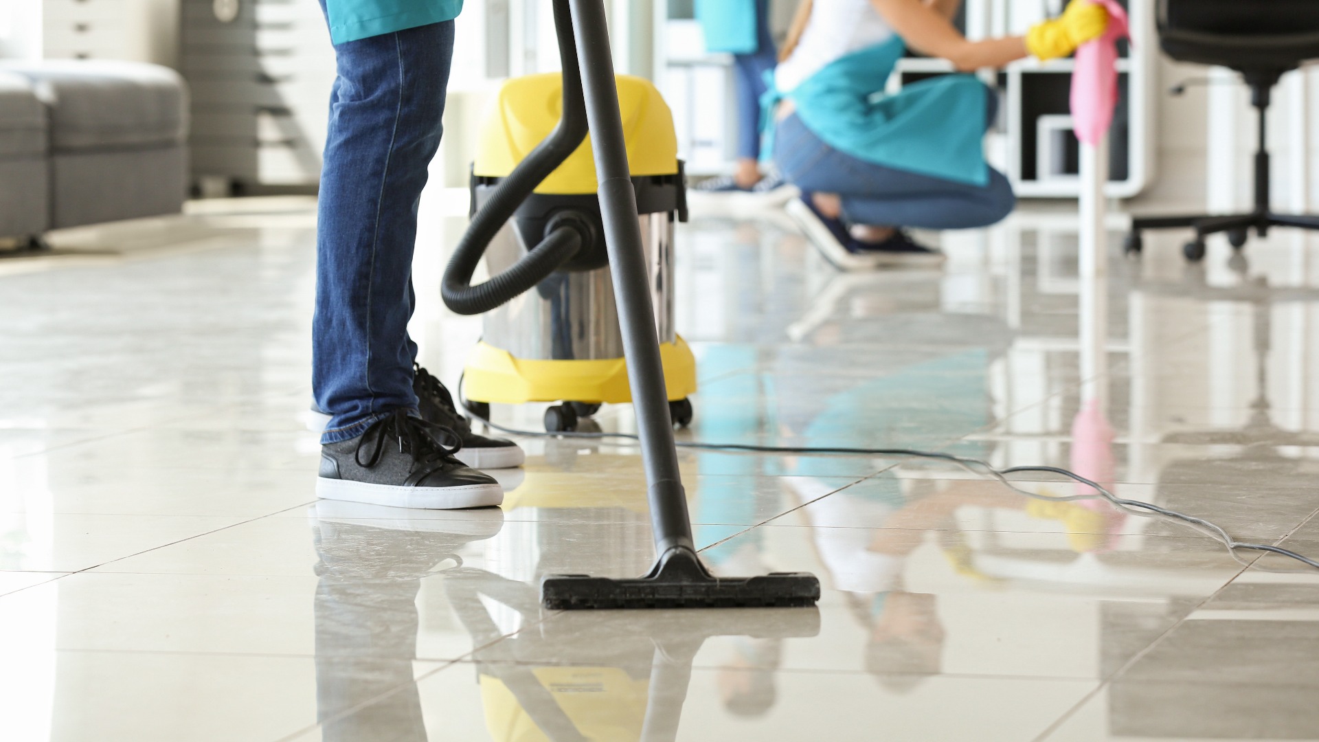 Janitor hoovering floor in office jpg